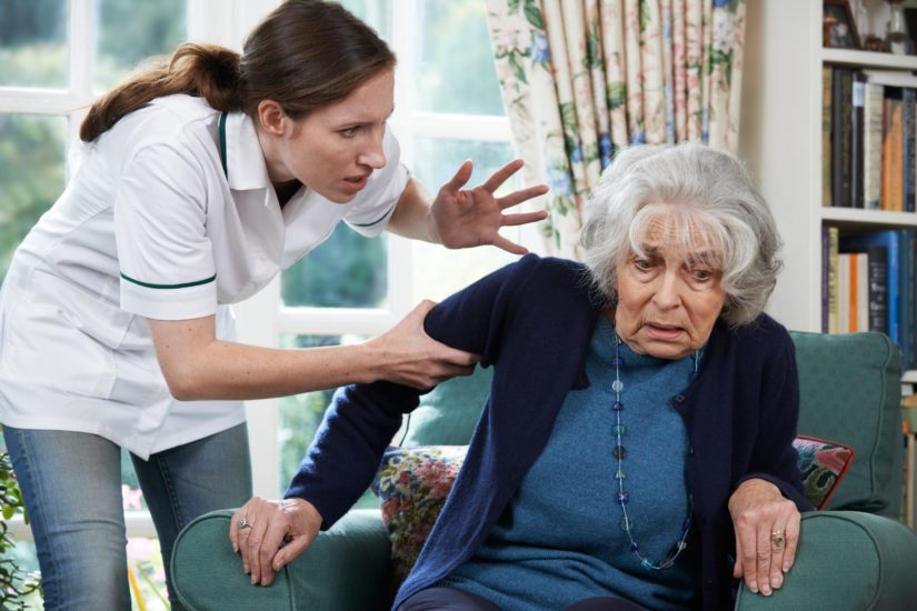 A nurse abusing an elderly woman in a nursing home