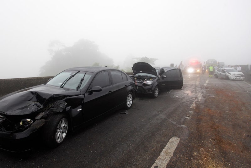 Two Damaged Black Cars On A Highway