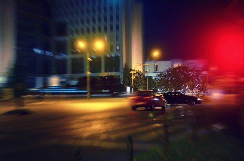 Red Car Speeding Away Crossing A Red Light