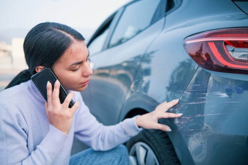 Photo of girl next to scratched car