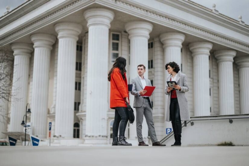 Photo of people in from of a large building